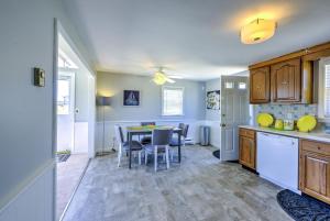 a kitchen and dining room with a table and chairs at Sagamore Beachfront Cottage Escape in Sagamore Beach