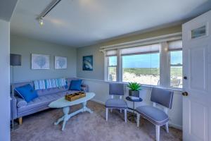 a living room with a couch and chairs and a table at Sagamore Beachfront Cottage Escape in Sagamore Beach +11 photos