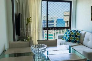 a living room with a couch and a glass table at Apartamento Royale na praia de Boa Viagem in Recife