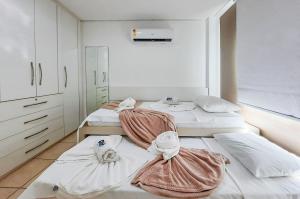 Habitación con 3 camas y toallas. en Confortável 3 Qtos 100m Praia - Vila do Porto, en Aquiraz