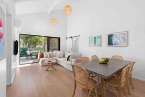 a living room with a table and chairs and a couch at So Beachy! 200m to the beach or shops! Sleeps 8 in Ocean Grove