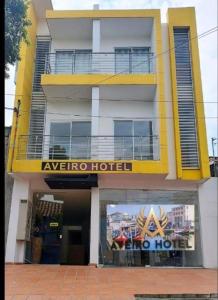 a hotel with a yellow and white building at Aveiro Hotel in Cúcuta