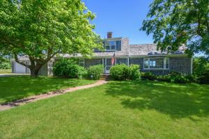 a house with a tree in front of a yard at 229 Scatteree Road North Chatham Cape Cod - - Nauset Watch in South Chatham