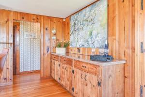 a room with wooden walls and a large painting on the wall at 229 Scatteree Road North Chatham Cape Cod - - Nauset Watch in South Chatham