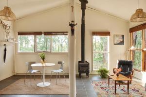 a living room with a table and a stove at Monga Mountain Retreat in Reidsdale