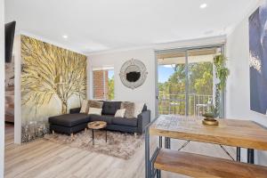 - un salon avec un canapé et une table dans l'établissement 12 Calming Coral Beach Beautiful 2brm, à Perth