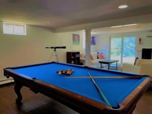a living room with a pool table in a room at Beach Glass—Space, Fun Furry Friends Welcome in Brewster