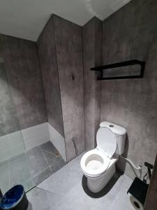 a bathroom with a toilet and a shower at Extreme Boutique Hotel in Kluang