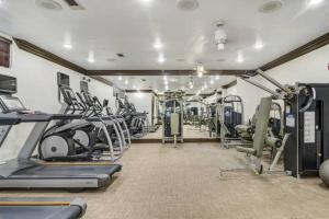 a gym with treadmills and machines in a room at Atlanta Luxurious Apartment in Atlanta