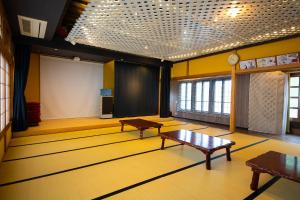 a large room with two tables and a screen at アメリカンハウスー野上 in Nagatoro