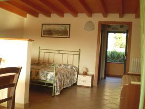 a bedroom with a bed in a room with a window at Agriturismo Renzano garden apartments in Salò +55 photos