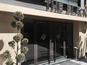 a building with glass doors and a sign on it at The Black Hotel in Eskisehir