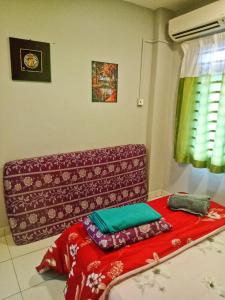 a living room with a couch with pillows on the floor at D'Mentari Laguna Super Seaview in Port Dickson