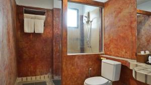 a bathroom with a toilet and a shower at Kalamona Seaview in Prachuap Khiri Khan