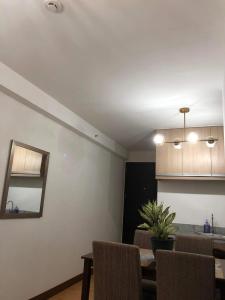 a kitchen and dining room with a table and chairs at Arezzo Condo Staycation in Davao City