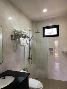 ein Bad mit einer Dusche, einem WC und einem Waschbecken in der Unterkunft New Skyway 