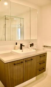 a bathroom with a sink and a mirror at RIVERVIEWS@THECOSMOPOLITAN UNIT20805 in Maroochydore
