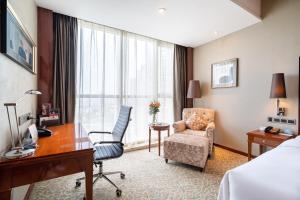 a hotel room with a desk and a chair at Crowne Plaza Zhenjiang, an IHG Hotel in Zhenjiang