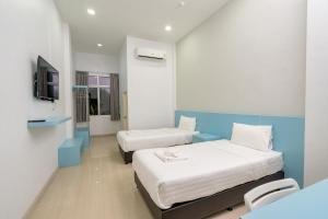 Tempat tidur dalam kamar di TOP INN โรงแรมท็อปอินน์