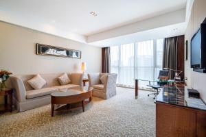a living room with a couch and a table at Crowne Plaza Zhenjiang, an IHG Hotel in Zhenjiang