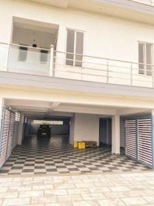 an empty parking garage with a car parked under a building at RASA - The Ganges Rishikesh, Ganga Bhumi Apartment in Rishīkesh