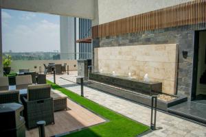 a building with a patio with a fireplace and grass at Elite Residences by Bednbeyond O72195O3I9 in Nairobi