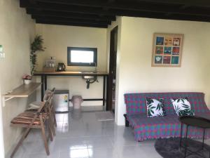 a living room with a couch and a tv at Villafarmsuk@khanom in Khanom