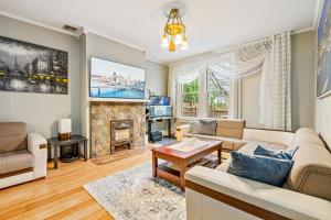 a living room with a couch and a fireplace at Cozy Stay in Pittsburgh in Pittsburgh