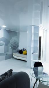 a living room with a couch and a glass table at Апартаменты с шикарным видом на море in Aktau
