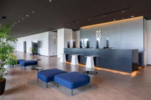 a lobby with blue chairs and a counter at The358 UMI in Fukuoka