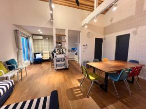 a living room with a wooden table and chairs at studio Symphonia x Fukutsu in Fukuma