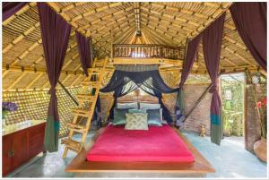 a bedroom with a large bed in a room at Firefly Eco Lodge in Ubud
