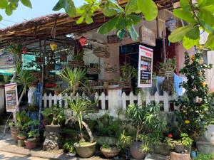 a store with potted plants and a white fence at Bai Huong homestay in Hoi An