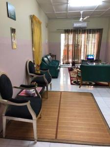 a living room with chairs and a pool table at irdahusna homestay 