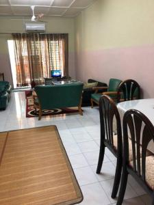 a living room with a table and chairs and a pool table at irdahusna homestay 