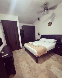 a bedroom with a large bed and a ceiling at Bonita casa Moon Penthouse en Cancún in Cancún
