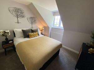 a bedroom with a bed with two trees on the wall at Cornish country getaway in Callington