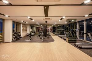 a gym with a lot of treadmills and machines at The Sóng Condotel in Vung Tau City - The Sóng Real Company in Vung Tau