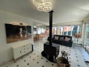 a living room with a fireplace and a tv at Puerto Pollensa Villa Nevada next to the Beach, private pool in Port de Pollensa