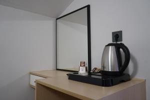 a mirror on a table with a coffee maker on it at MOF Comfort Edirne in Edirne