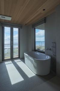 a large bathroom with a tub and a large window at Hijau 青嶼味旅行館 in Green Island