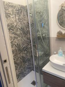 a shower with a glass door next to a sink at La finestra sul castello in Sestola