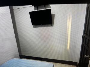 a flat screen tv on the wall of a room at Danao LC Bayview in Idanao