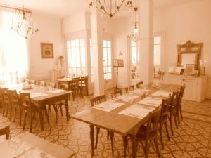 a large room with wooden tables and chairs in it at Hôtel De La Providence in Égliseneuve-dʼEntraigues