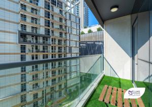 a balcony with a view of a tall building at Luke Stays - Dunya Tower in Dubai