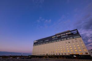 a tall building with a blue sky in the background at The358 SORA in Fukuoka