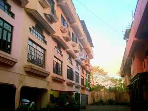 a building with balconies on the side of it at TAAL VIEW: Townhouse with Pool, Netflix, PS4, Foosball, Karaoke in Tagaytay