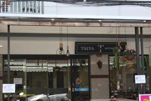 a store front with a sign that reads taza at Talya Patong Hotel in Patong Beach