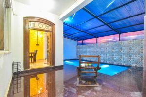 a room with a pool and a table in it at Dev1villa in Lonavala