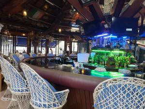 a bar in a restaurant with chairs and a bar counter at PALM TREE RESORT AND RESTAURANT in Olongapo